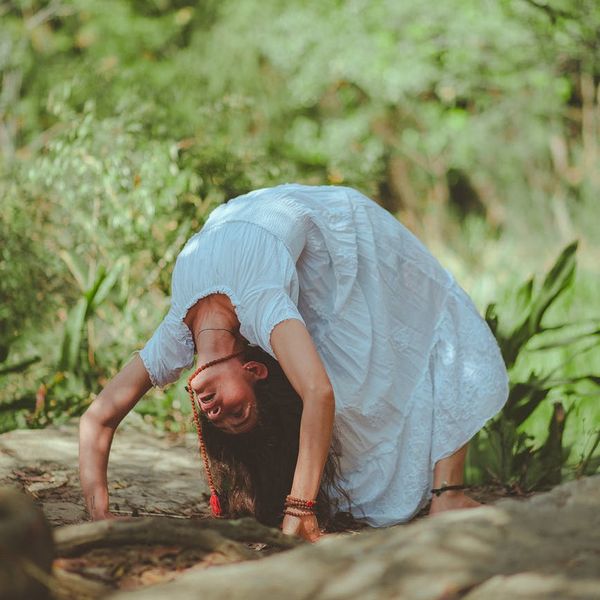Person meditating peacefully in a calm environment with a subtle green aura effect.